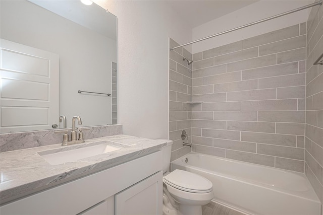 full bathroom with toilet, tiled shower / bath combo, and vanity