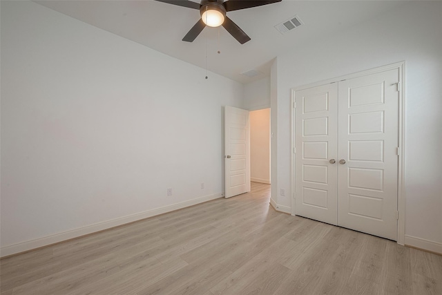 unfurnished bedroom featuring ceiling fan, a closet, and light hardwood / wood-style floors