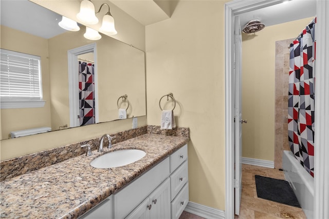 bathroom featuring vanity, shower / bath combo with shower curtain, and baseboards