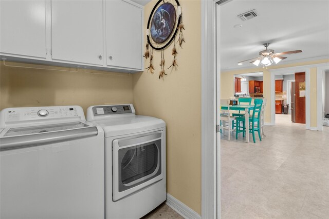 2602 Gerol Ct, Galveston, TX 77551 - laundry area featuring baseboards, visible vents, a ceiling fan, independent washer and dryer, and cabinet space