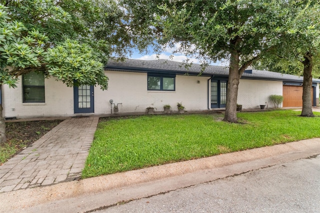 2602 Gerol Ct, Galveston, TX 77551 - single story home with brick siding, french doors, a shingled roof, and a front yard