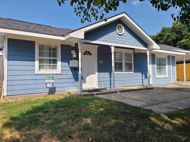 view of front of home with a front yard and a porch