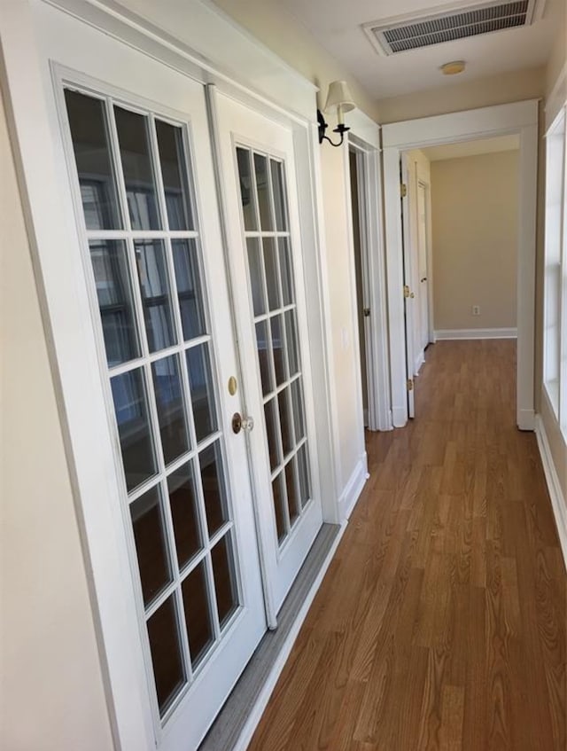 corridor featuring dark hardwood / wood-style flooring