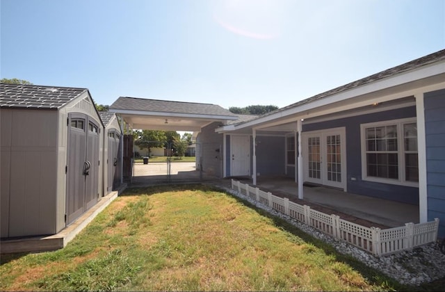 view of yard with a storage shed and french doors