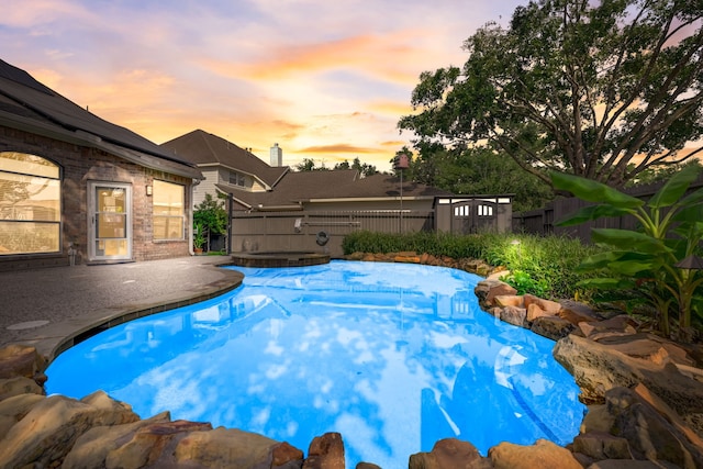 view of pool at dusk