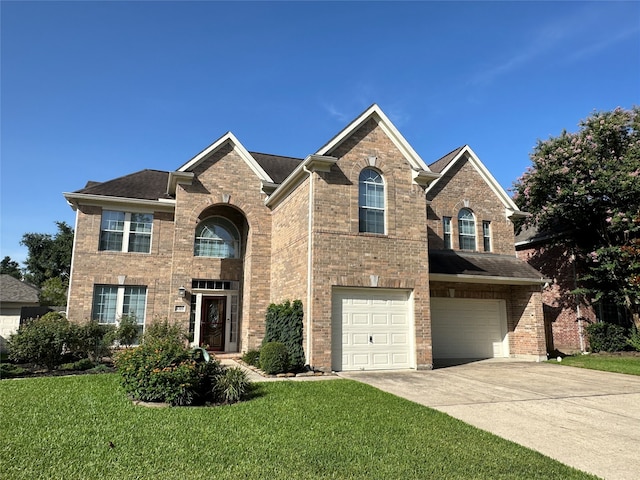 view of property featuring a front lawn and a garage