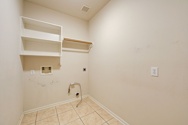 washroom with washer hookup, gas dryer hookup, light tile patterned flooring, and electric dryer hookup