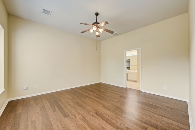 unfurnished room featuring ceiling fan and hardwood / wood-style floors