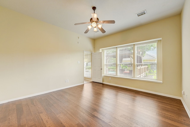 spare room with hardwood / wood-style flooring and ceiling fan