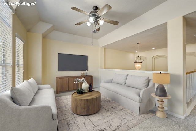 carpeted living room with ceiling fan