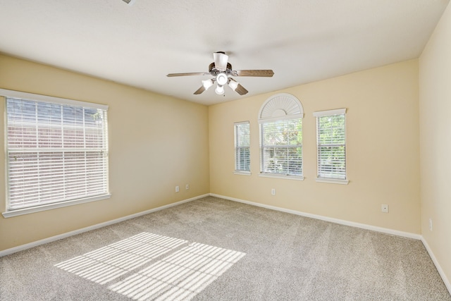 carpeted spare room with ceiling fan