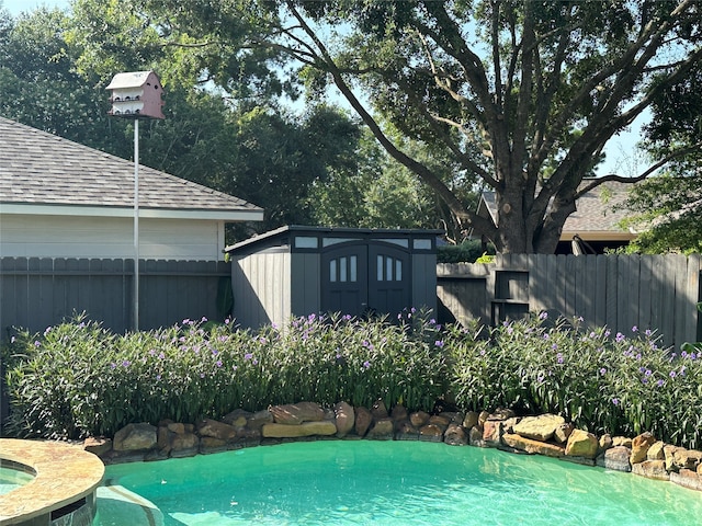 view of pool with a shed