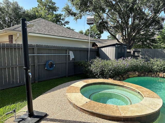 view of pool with an in ground hot tub