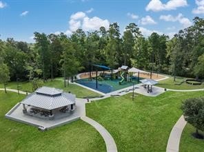 view of community with a lawn and a playground