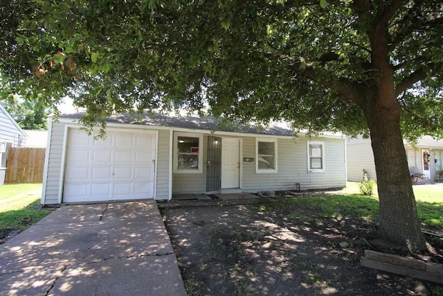 1507 Demaree Ln, Houston, TX 77029 - view of front facade with concrete driveway, a garage, and fence