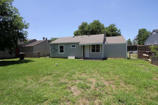 rear view of property with a yard