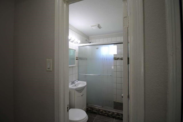 1507 Demaree Ln, Houston, TX 77029 - full bathroom with a stall shower, tile patterned floors, a textured wall, vanity, and toilet