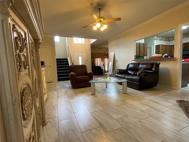 living room with ceiling fan and crown molding