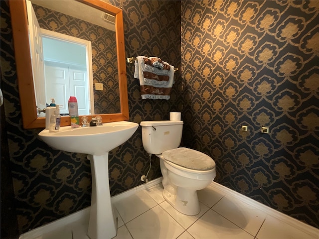 bathroom with toilet and tile patterned floors