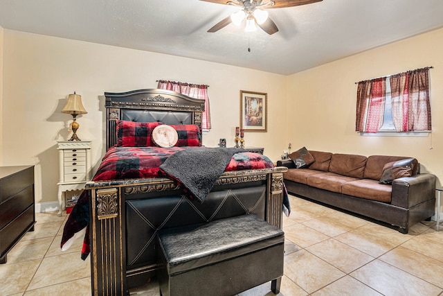 bedroom with ceiling fan and light tile patterned floors