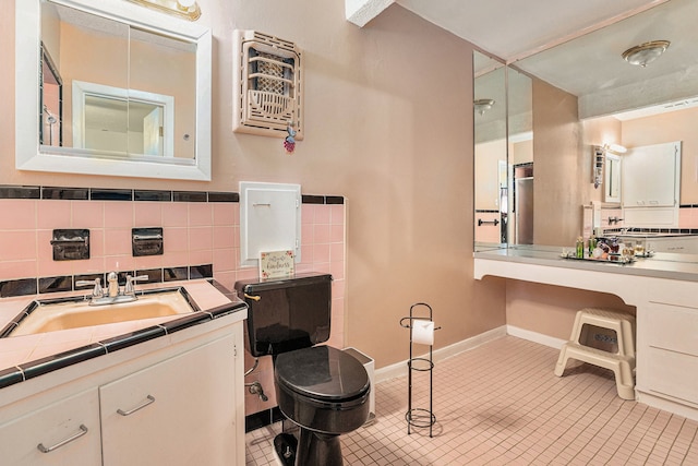 bathroom with toilet, tile patterned flooring, vanity, heating unit, and decorative backsplash