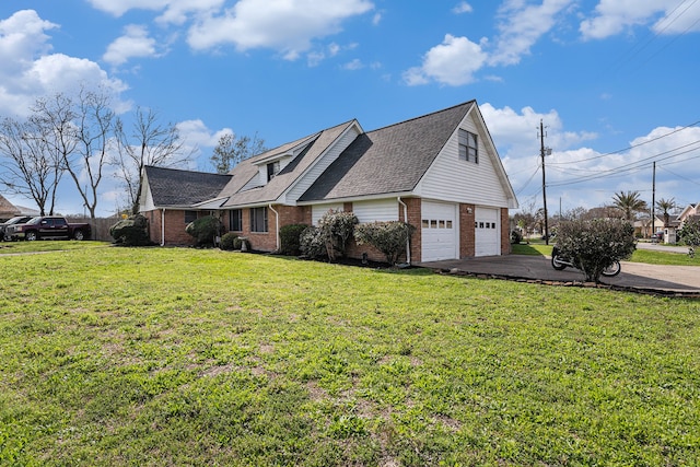 view of side of property featuring a yard and a garage