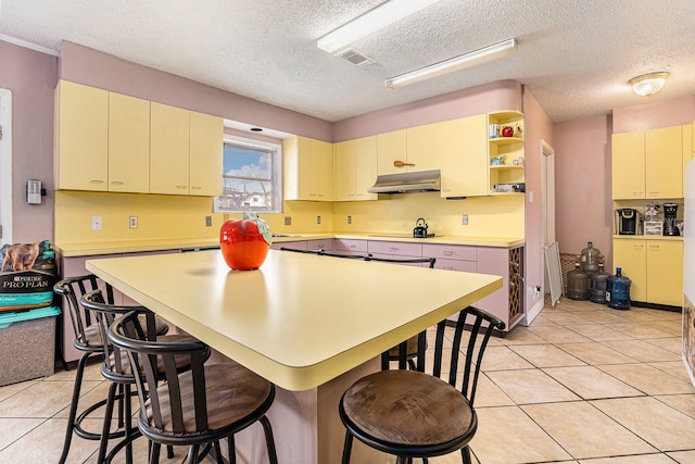 kitchen featuring a textured ceiling, black gas cooktop, and light tile patterned floors