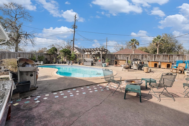 view of pool with a fire pit, a pergola, and a patio area