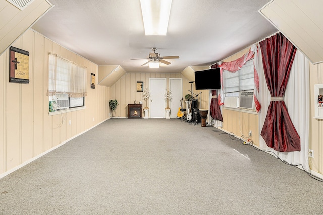 interior space featuring a healthy amount of sunlight, ceiling fan, and carpet flooring