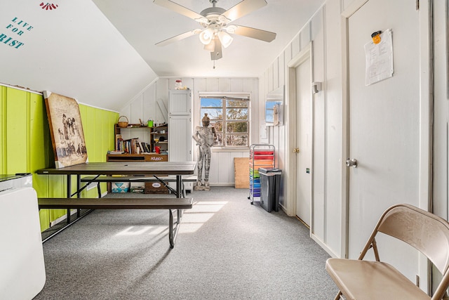 interior space featuring light colored carpet, ceiling fan, and vaulted ceiling