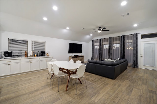 interior space featuring ceiling fan, vaulted ceiling, and light hardwood / wood-style flooring