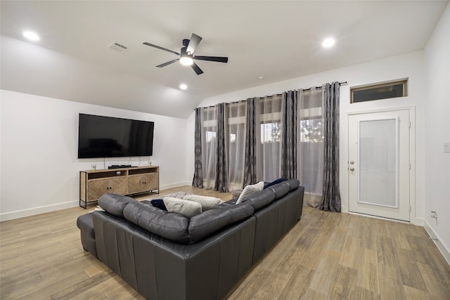 living room with lofted ceiling, ceiling fan, and light hardwood / wood-style floors