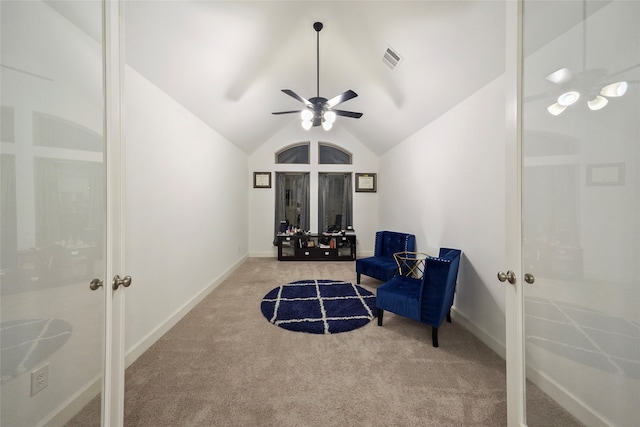 sitting room with lofted ceiling, ceiling fan, and light carpet