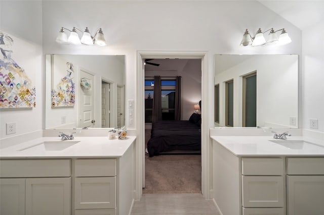 bathroom featuring lofted ceiling and vanity