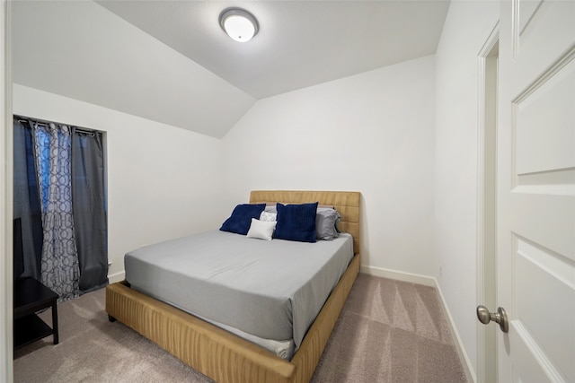 bedroom with lofted ceiling and carpet flooring