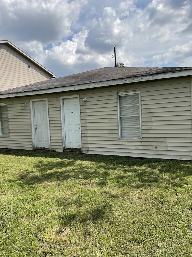 view of side of property with a yard