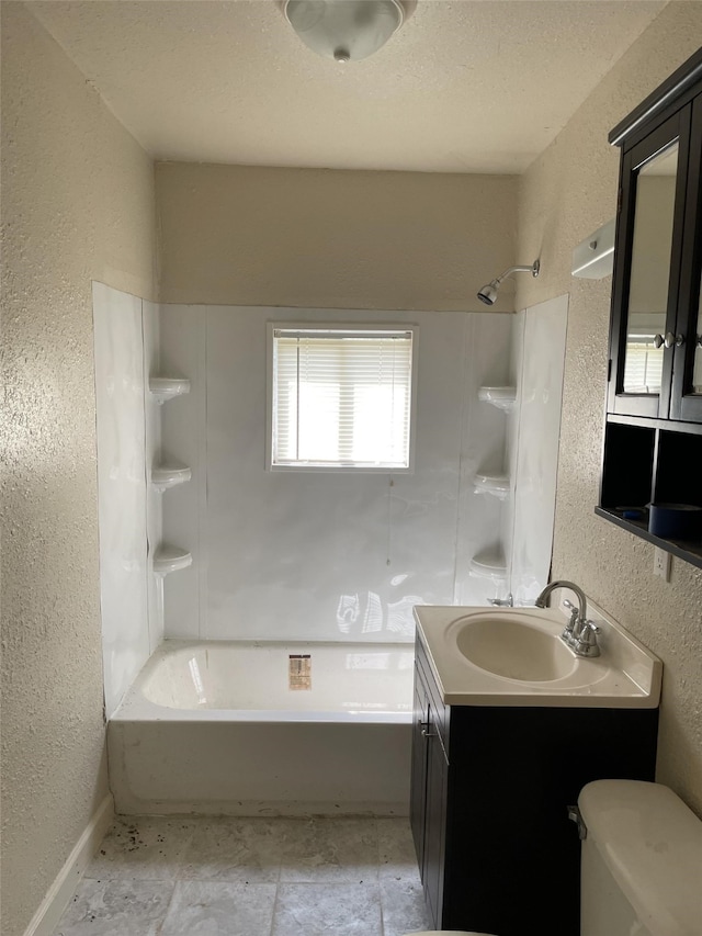 full bathroom featuring a textured ceiling, vanity, toilet, and shower / tub combination