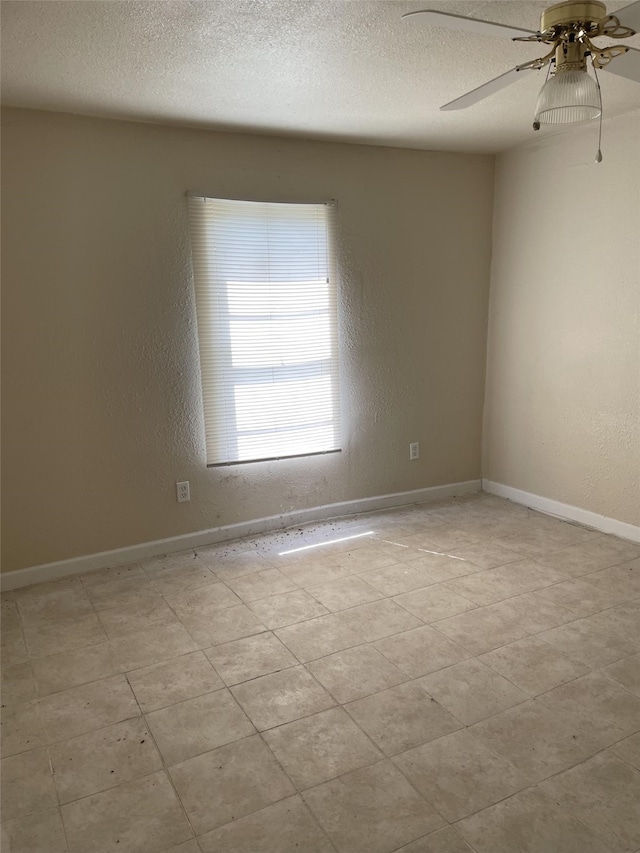 empty room featuring ceiling fan and a textured ceiling