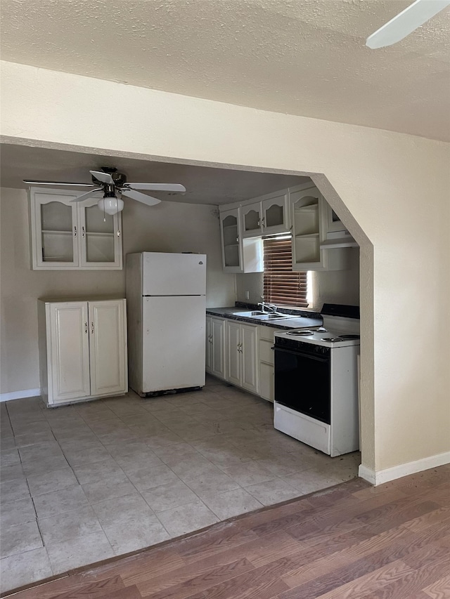 kitchen featuring a textured ceiling, ceiling fan, light wood-type flooring, and white appliances