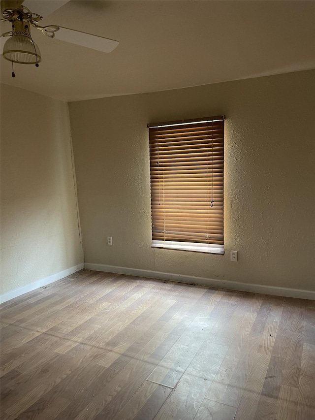 spare room featuring hardwood / wood-style flooring and ceiling fan