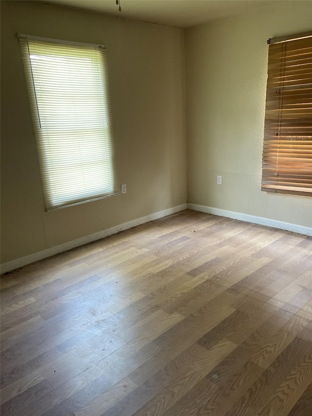 spare room with hardwood / wood-style floors