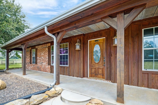 view of exterior entry featuring a porch