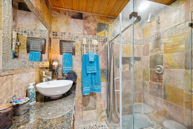 bathroom featuring a shower with door, wood ceiling, and sink