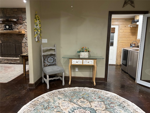 living area with a fireplace and washing machine and dryer