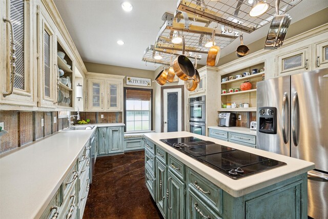 kitchen featuring a kitchen island, appliances with stainless steel finishes, tasteful backsplash, sink, and green cabinetry