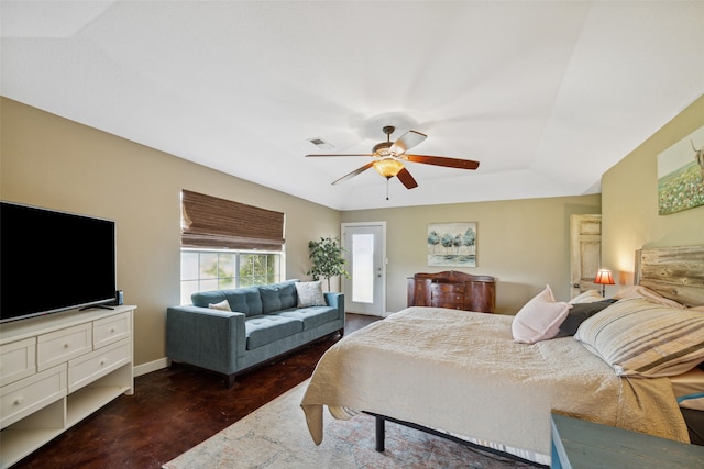 bedroom with ceiling fan and a tray ceiling