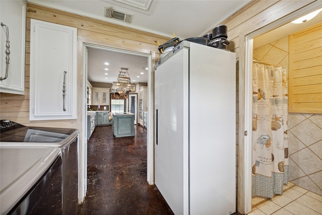 kitchen featuring white cabinetry, washer and dryer, and white fridge