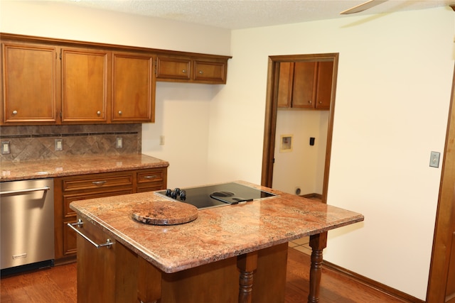 kitchen with a breakfast bar, dark hardwood / wood-style flooring, light stone countertops, black electric stovetop, and stainless steel dishwasher