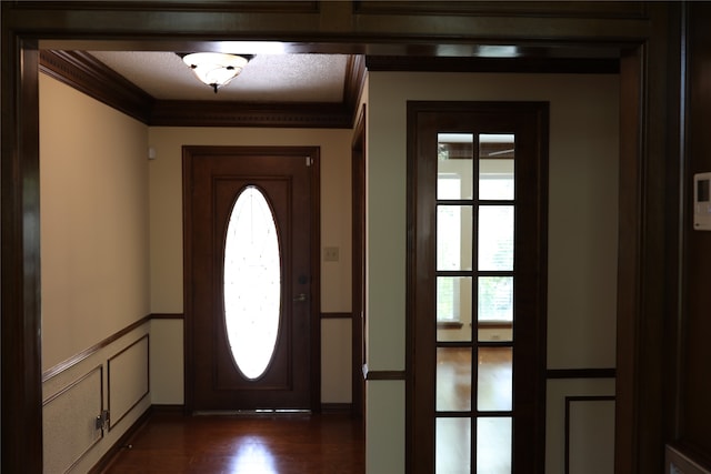 entryway featuring dark hardwood / wood-style floors and ornamental molding