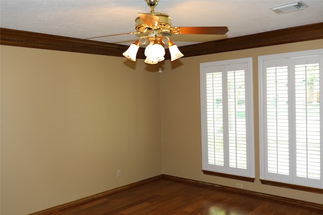 unfurnished room with ceiling fan, a textured ceiling, crown molding, and dark hardwood / wood-style flooring